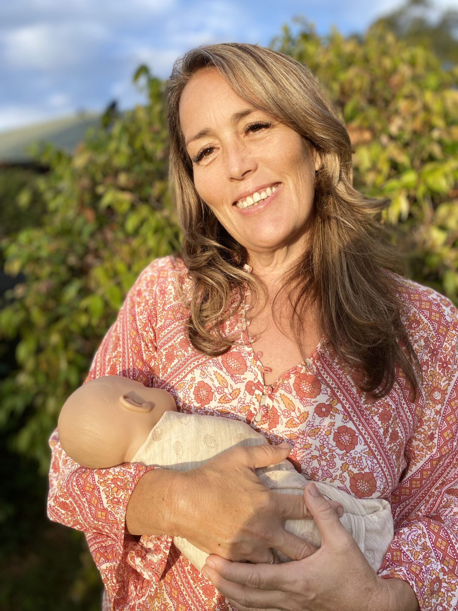 Raquel Tara holding newborn baby